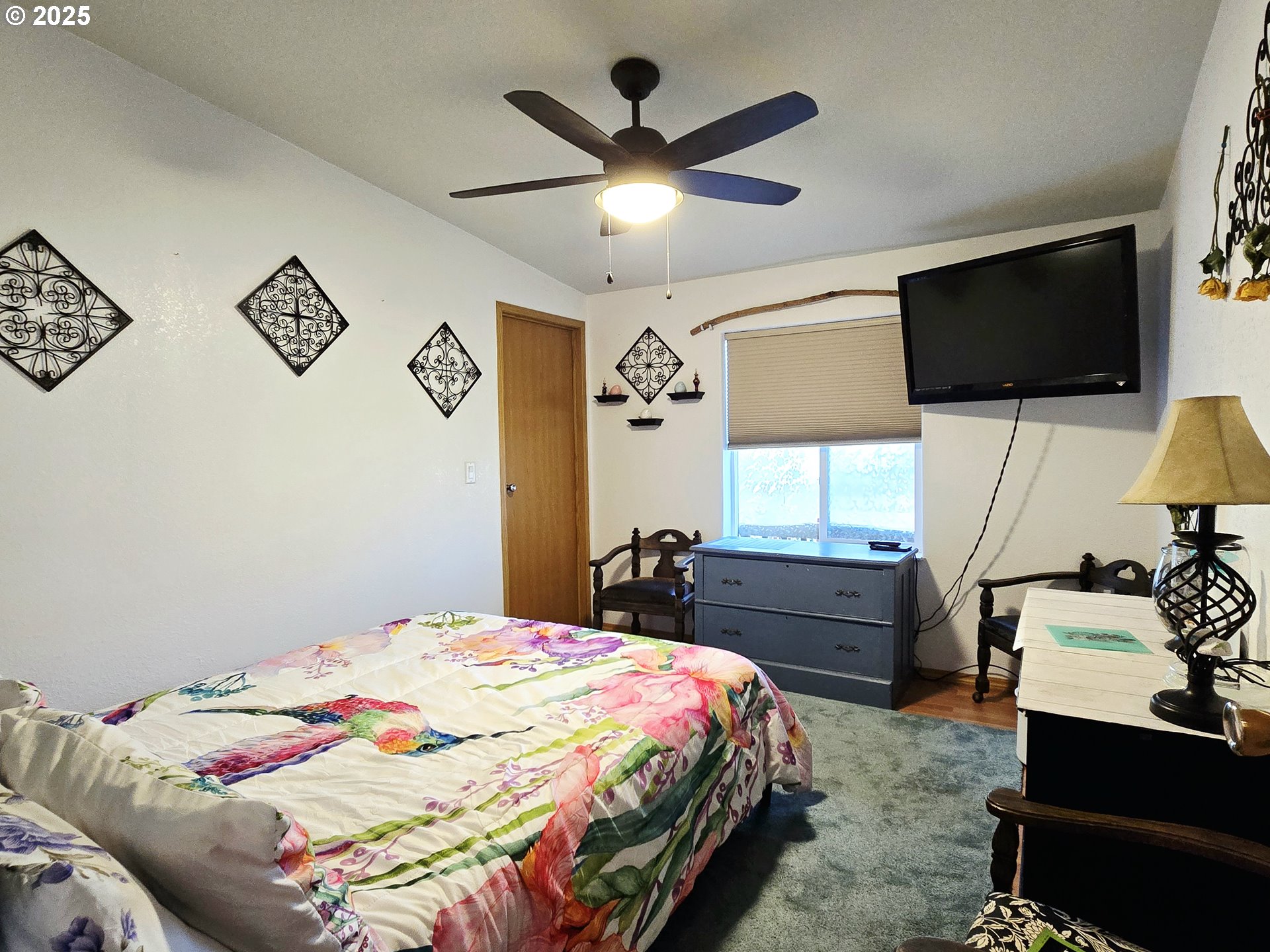 96465 Coverdell Road, Unit 8 Brookings, OR 97415 - Photo 41 of 42 a bedroom with a bed and a flat screen tv