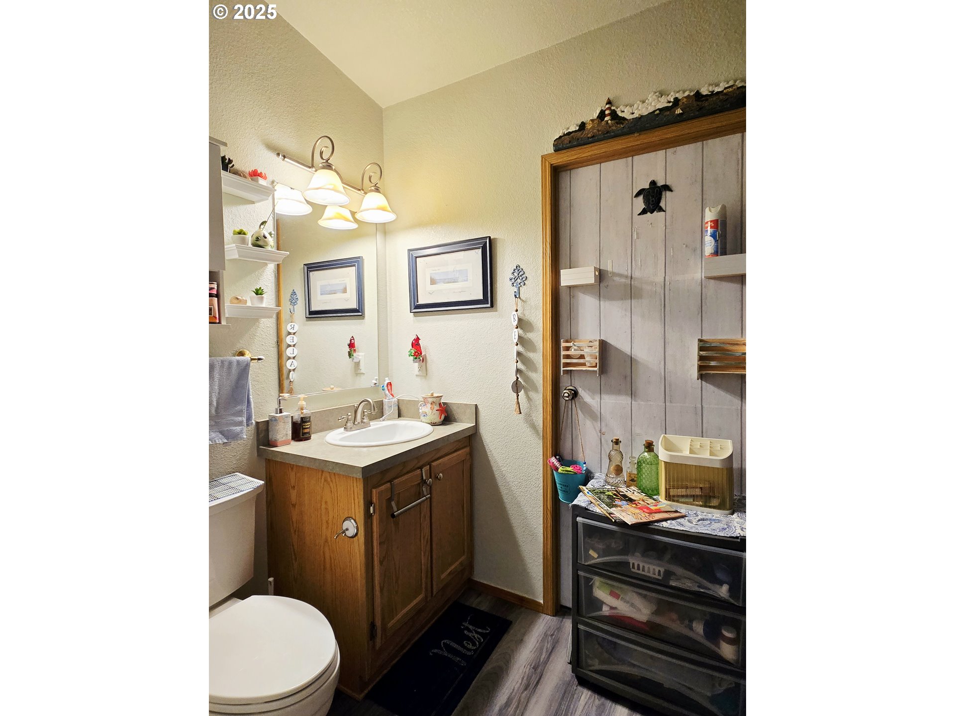 96465 Coverdell Road, Unit 8 Brookings, OR 97415 - Photo 42 of 42 a bathroom with a granite countertop toilet sink and mirror