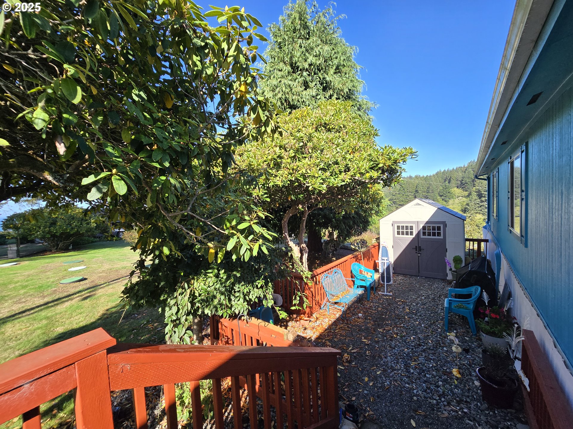 96465 Coverdell Road, Unit 8 Brookings, OR 97415 - Photo 9 of 42 a view of a yard with an outdoor space