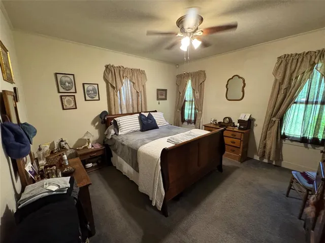 a spacious bedroom with a bed and a chandelier