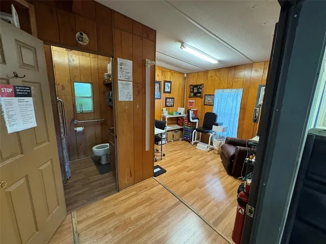 a room with furniture a flat screen tv and a window