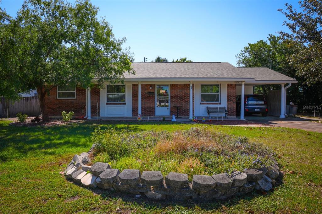 a view of a house with a yard patio and swimming pool