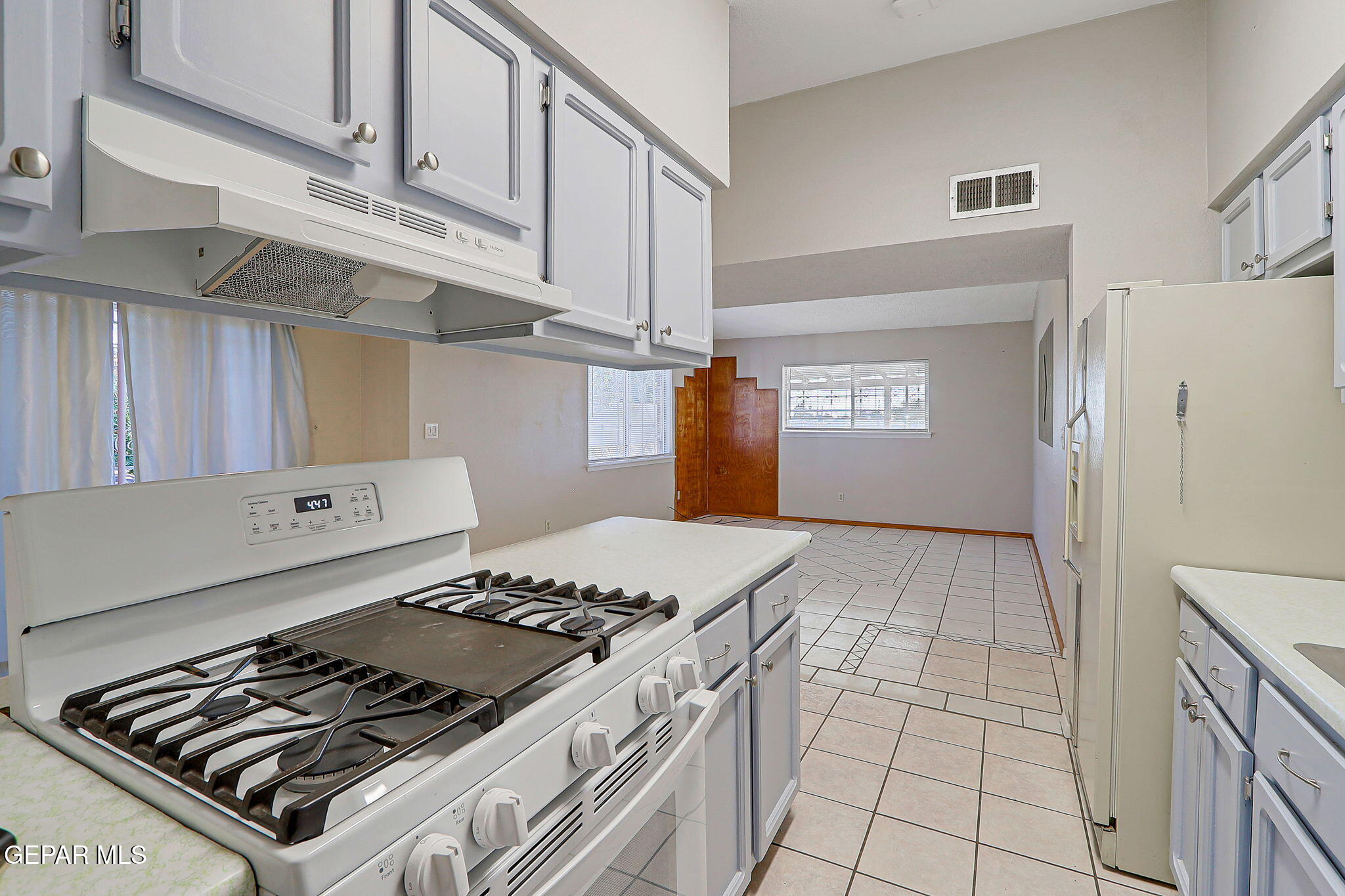 9108 Morelia Road El Paso, TX 79907 - Photo 13 of 35 a kitchen with a stove and a refrigerator