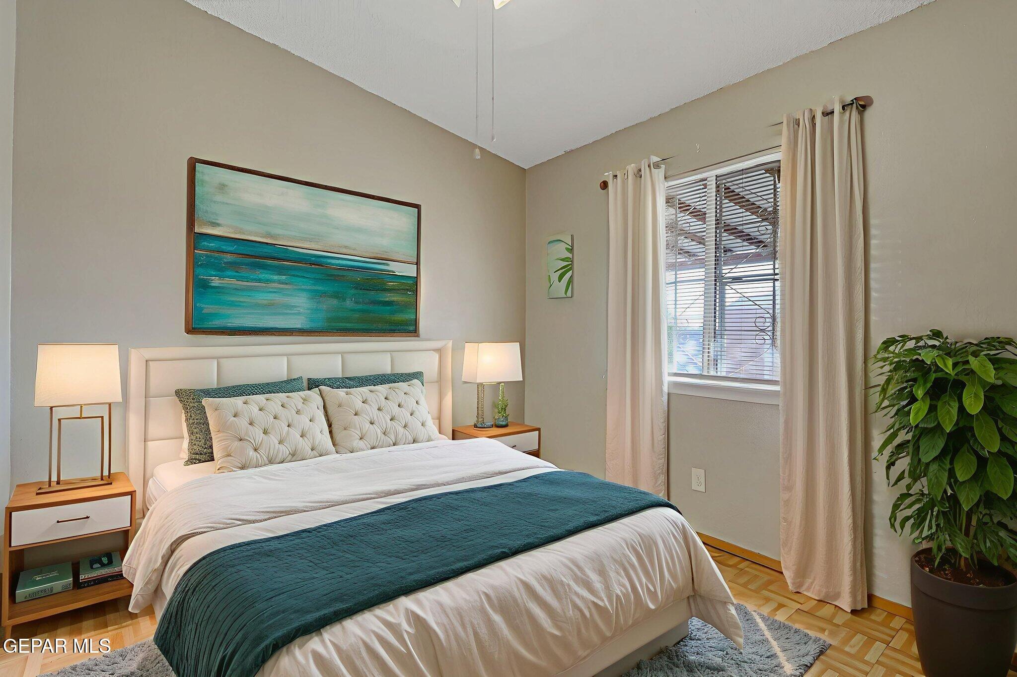 9108 Morelia Road El Paso, TX 79907 - Photo 33 of 35 a bedroom with a bed and a potted plant