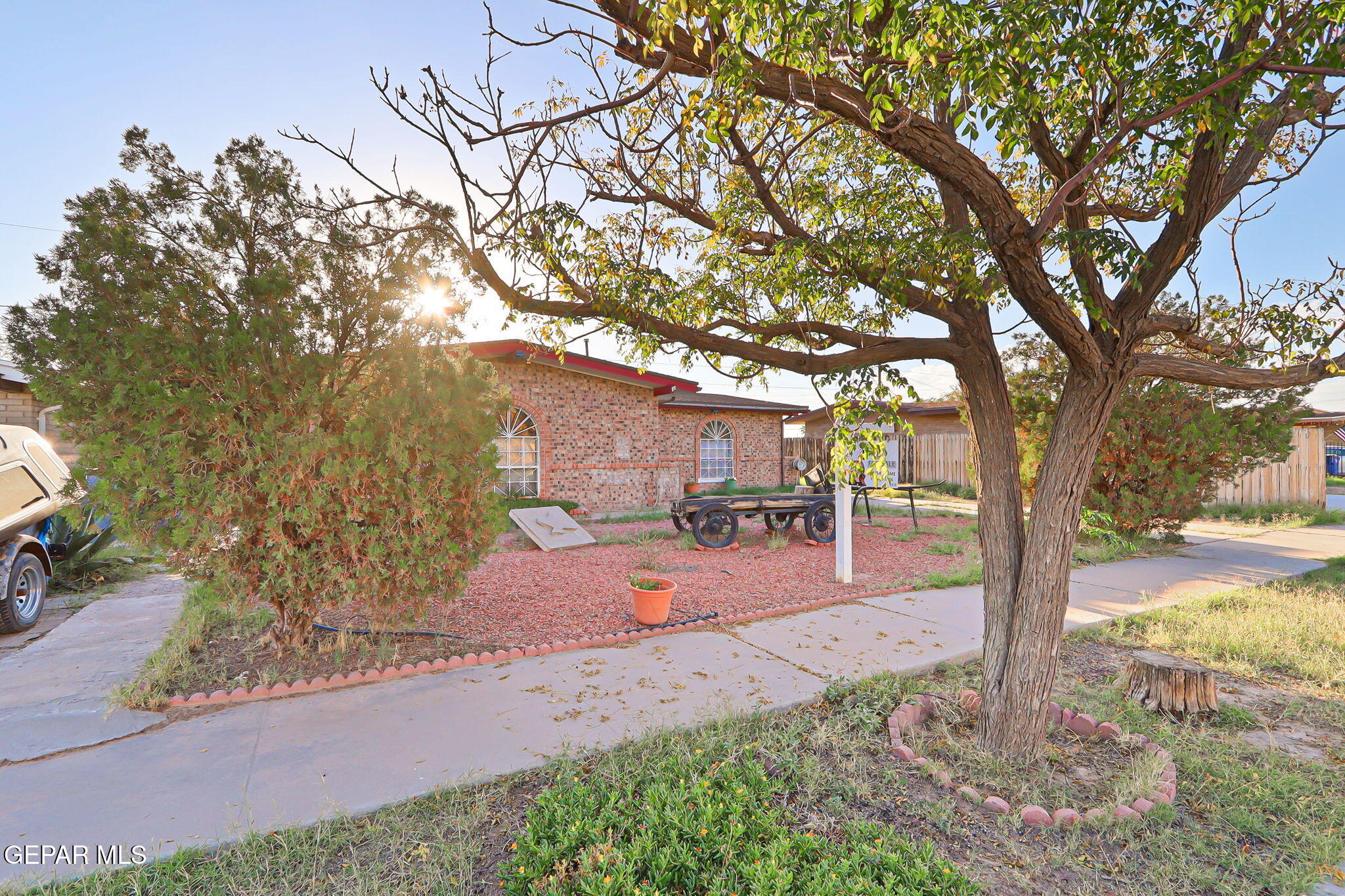 9108 Morelia Road El Paso, TX 79907 - Photo 5 of 35 a wooden bench sitting in front of a building