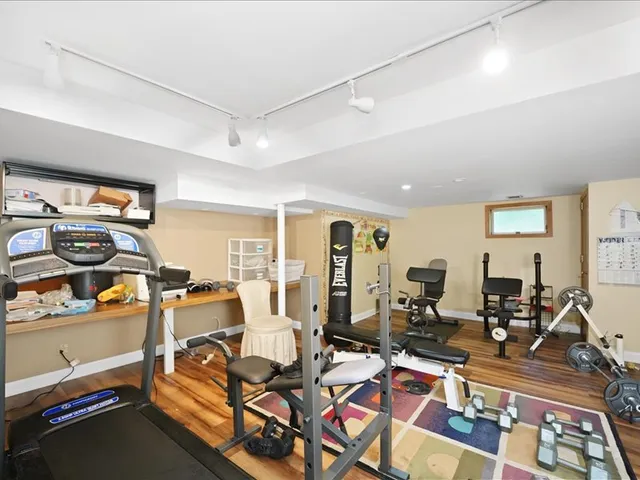 a living room with lots of furniture and gym equipment