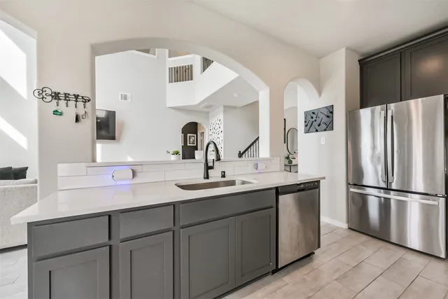a kitchen with a sink and refrigerator