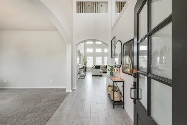 a view of entryway and hall with wooden floor