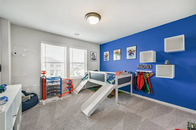 a living room with furniture gym equipment and a large window