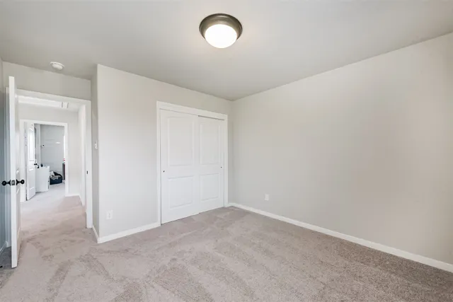 an empty room with fan and windows