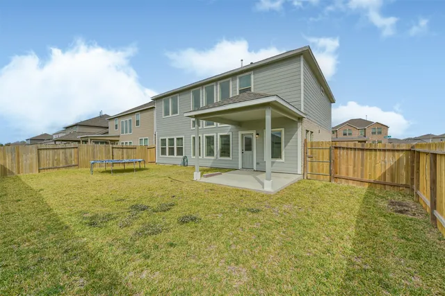 a front view of a house with a yard balcony and swimming pool