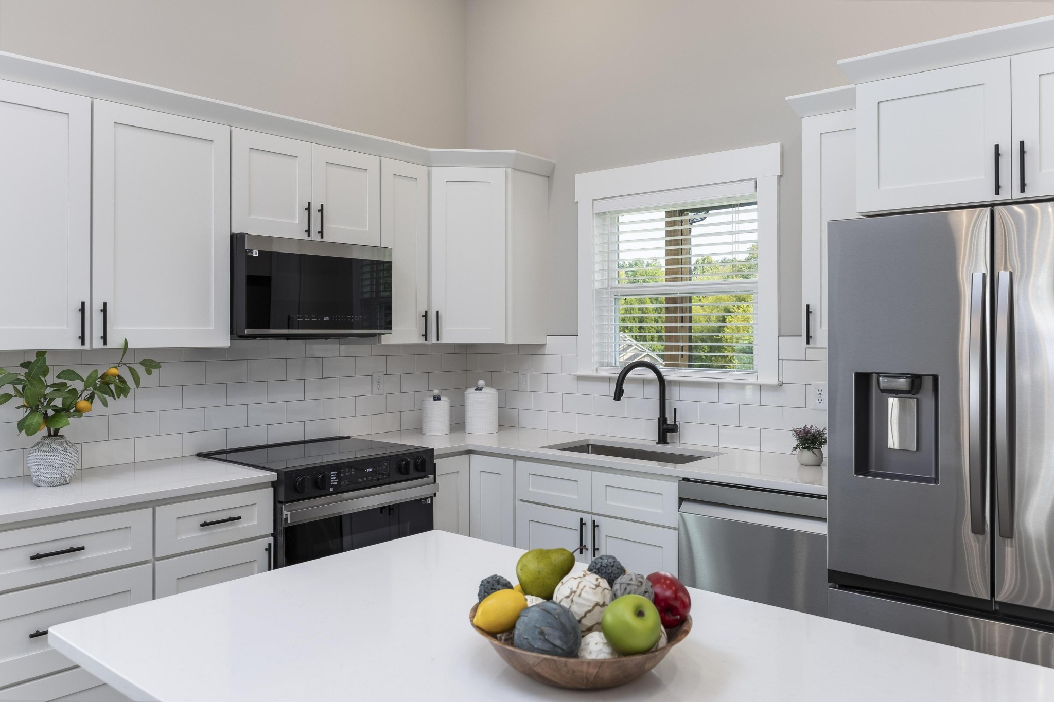 2151 Old Federal Road Ocoee, TN 37361 - Photo 12 of 31 a kitchen with stainless steel appliances a sink a stove a microwave a refrigerator and cabinets