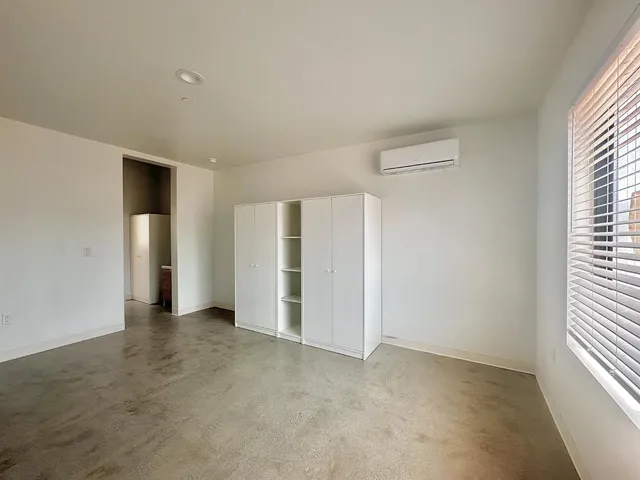 an empty room with a empty space and windows