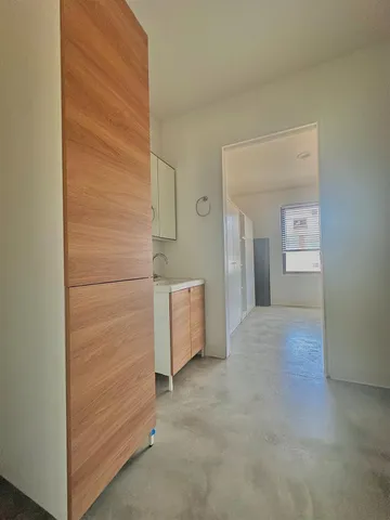 a bathroom with a granite countertop toilet and a mirror