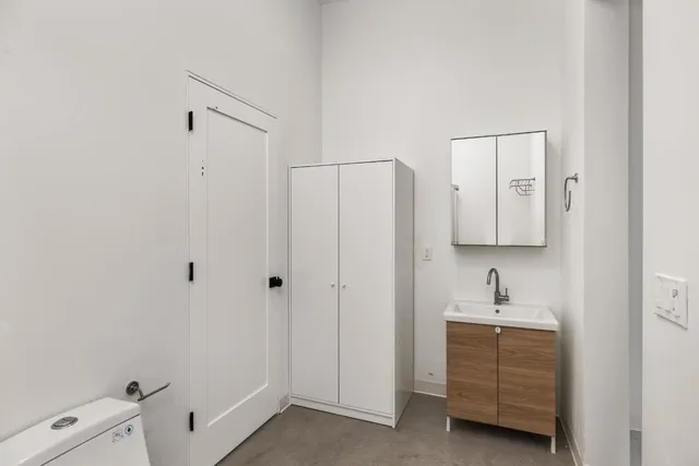 a bathroom with a granite countertop toilet and a shower