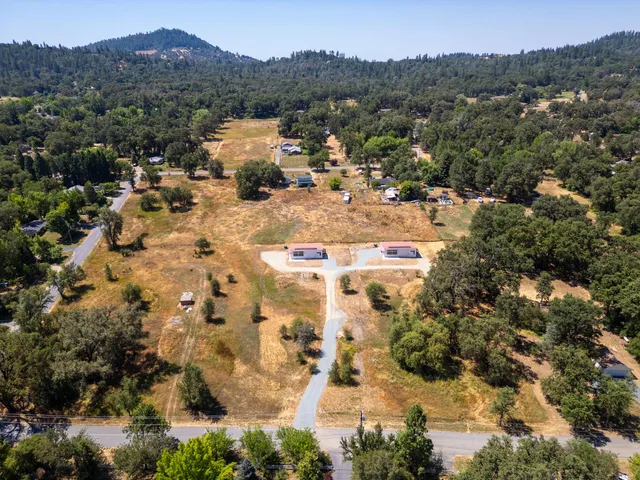 an aerial view of residential house with outdoor space and mountain view