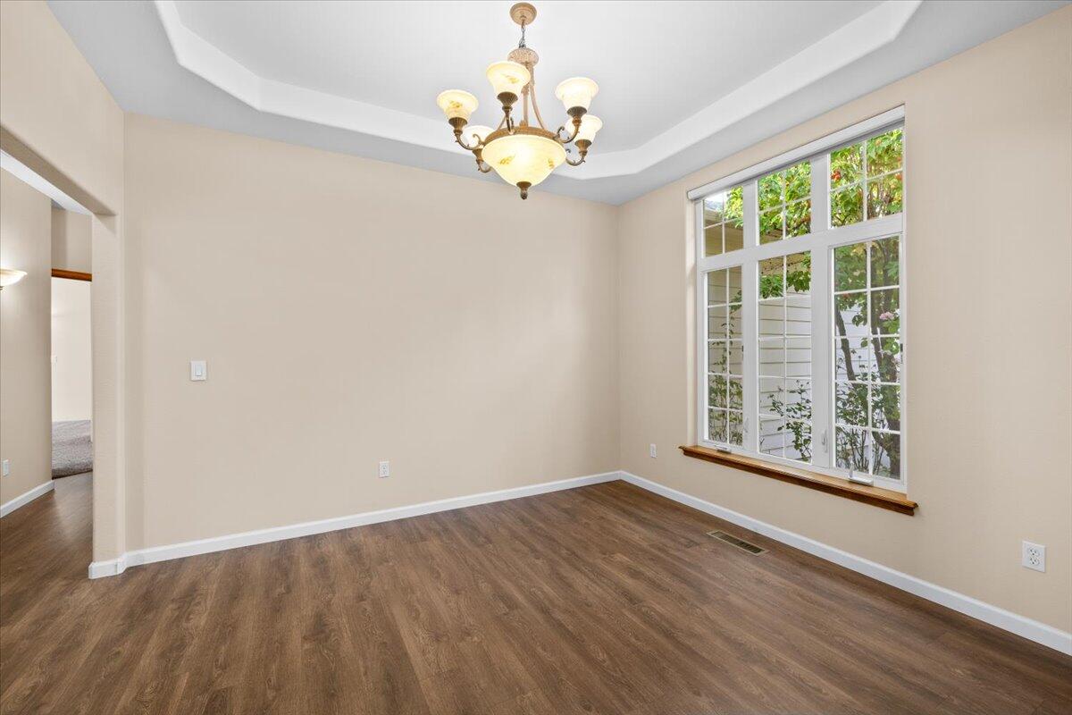 802 Ridgeway Avenue Central Point, OR 97502 - Photo 7 of 33 wooden floor in an empty room with a window