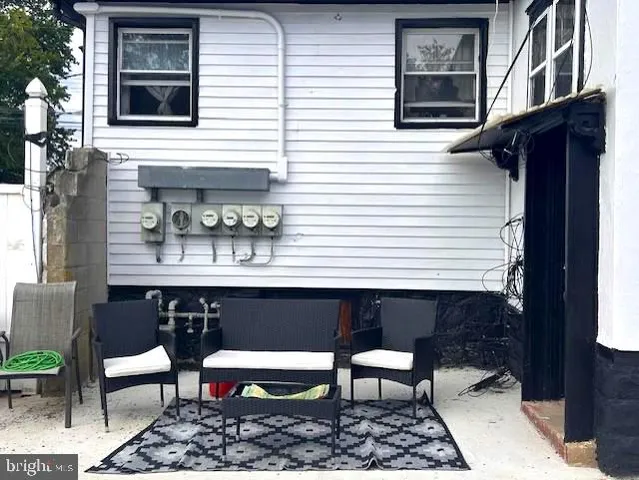 a view of a chairs and table in the backyard