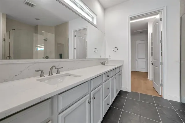 a bathroom with a shower and a sink