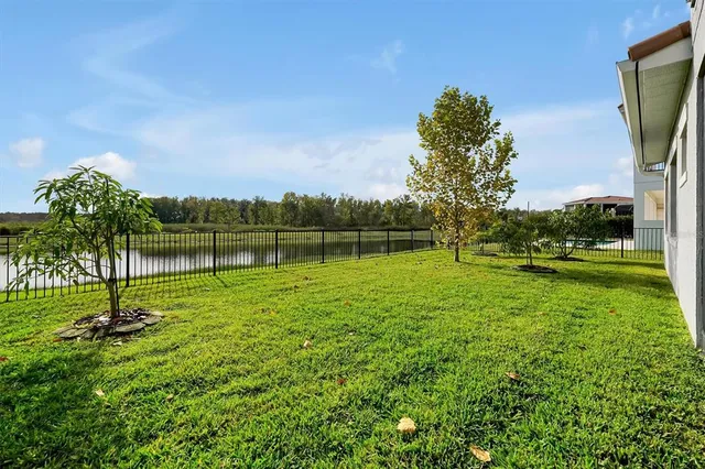 a view of an empty room and window a ceiling fan