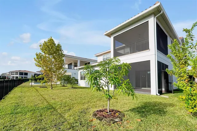 a view of swimming pool with outdoor seating and yard in back