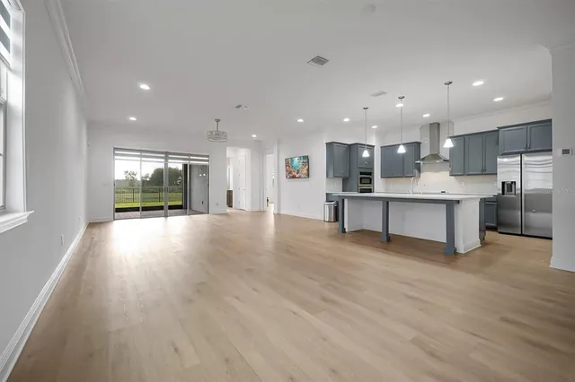 a view of kitchen with cabinets and wooden floor