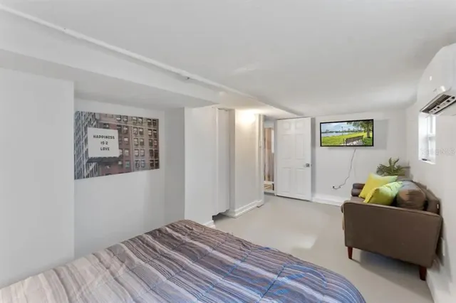 a kitchen with granite countertop a stove a oven a clock and white cabinets with wooden floor