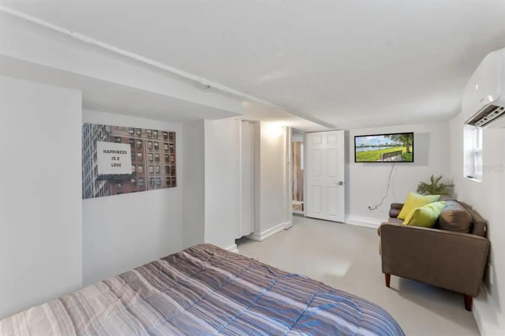 3320 18th Street North St. Petersburg, FL 33713 - Photo 12 of 28 a bedroom with a bed and a couch