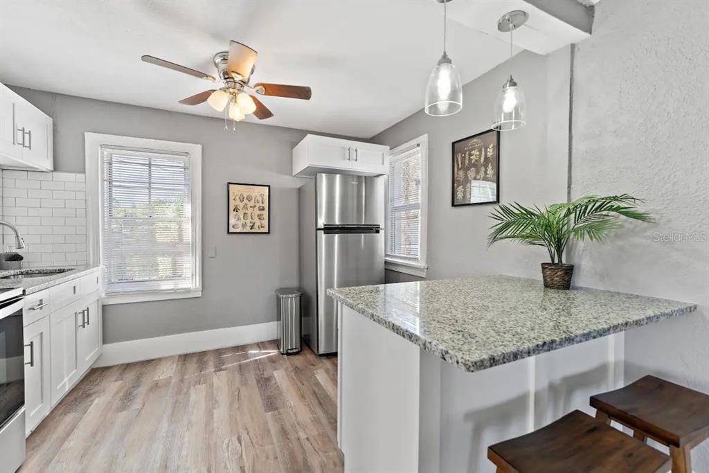 3320 18th Street North St. Petersburg, FL 33713 - Photo 20 of 28 a kitchen with stainless steel appliances granite countertop stove top oven and refrigerator
