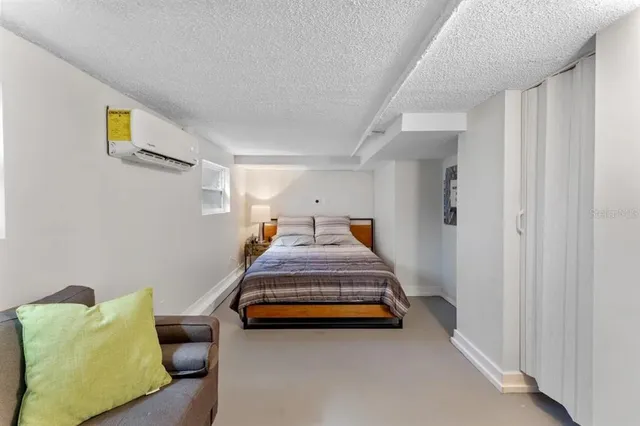 a bedroom with a bed table and a couch