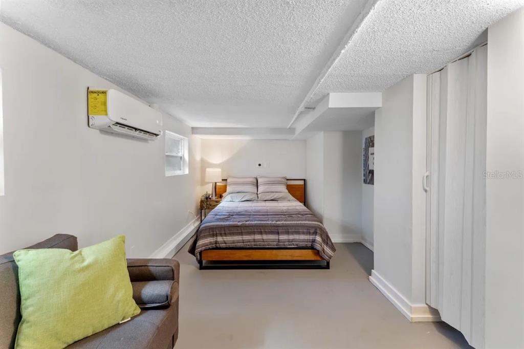 3320 18th Street North St. Petersburg, FL 33713 - Photo 24 of 28 a spacious bedroom with a bed and painting on the wall