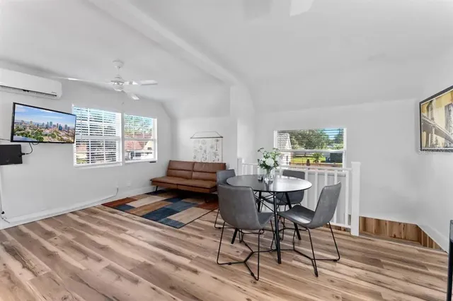a living room with furniture and a painting on the wall