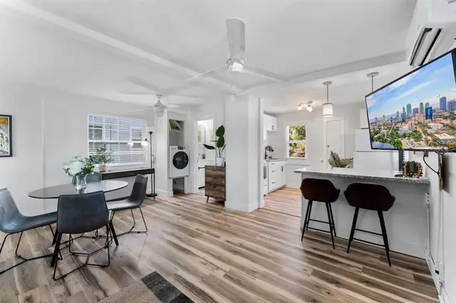 a kitchen with white cabinets and appliances