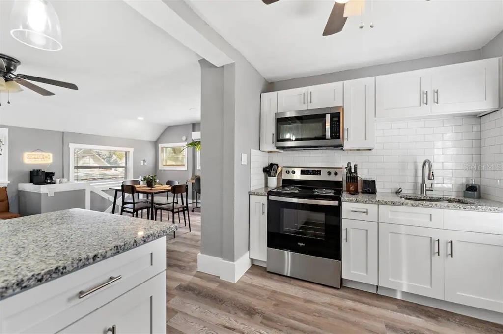 3320 18th Street North St. Petersburg, FL 33713 - Photo 7 of 28 a kitchen with white cabinets and appliances