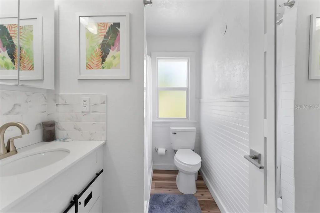 3320 18th Street North St. Petersburg, FL 33713 - Photo 10 of 28 a bathroom with a toilet sink and mirror