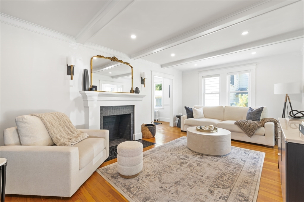 a living room with furniture a fireplace and a window
