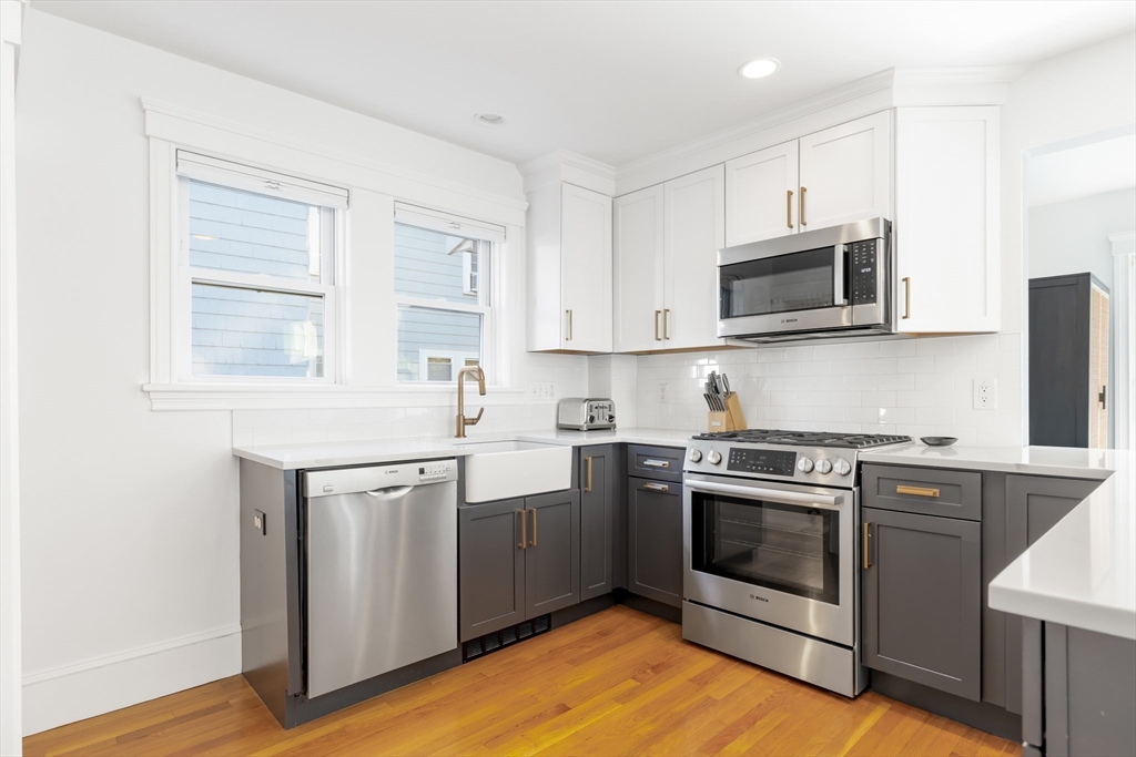 5 Intervale Road Wellesley, MA 02481 - Photo 6 of 29 a kitchen with stainless steel appliances granite countertop a stove a sink and a microwave