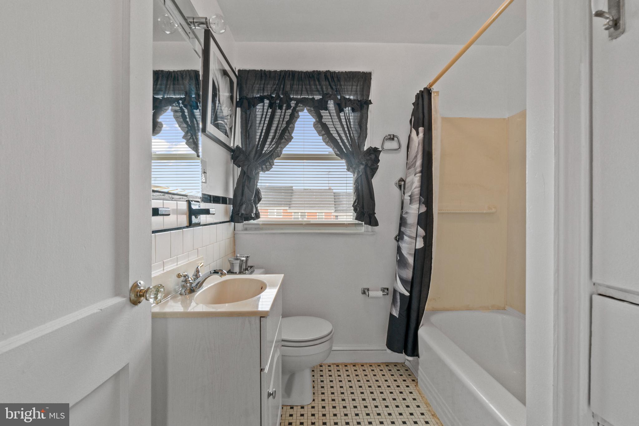 1909 Heathfield Road Baltimore, MD 21239 - Photo 11 of 22 a bathroom with a sink toilet and shower