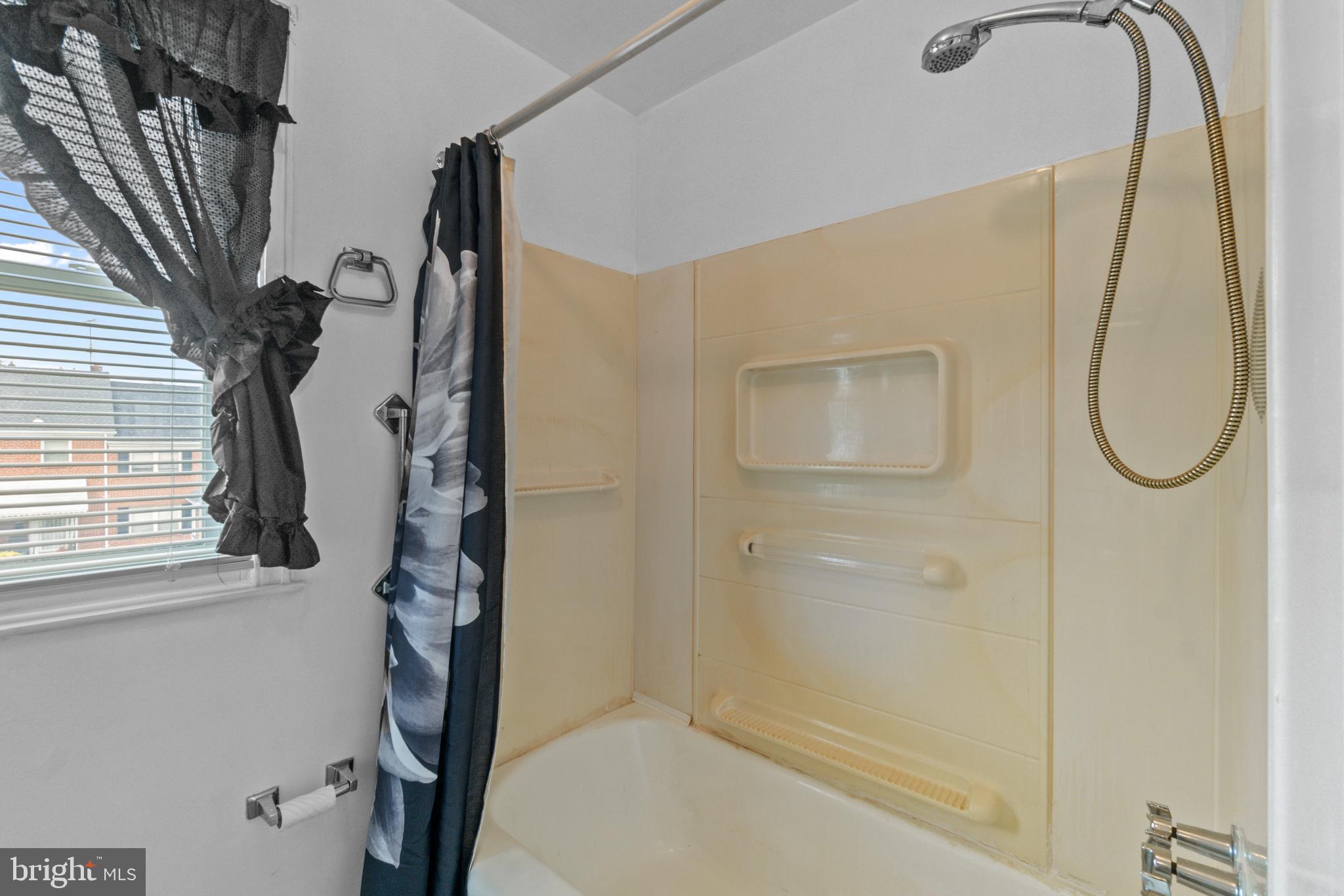 1909 Heathfield Road Baltimore, MD 21239 - Photo 12 of 22 a bathroom with a tub shower and a sink