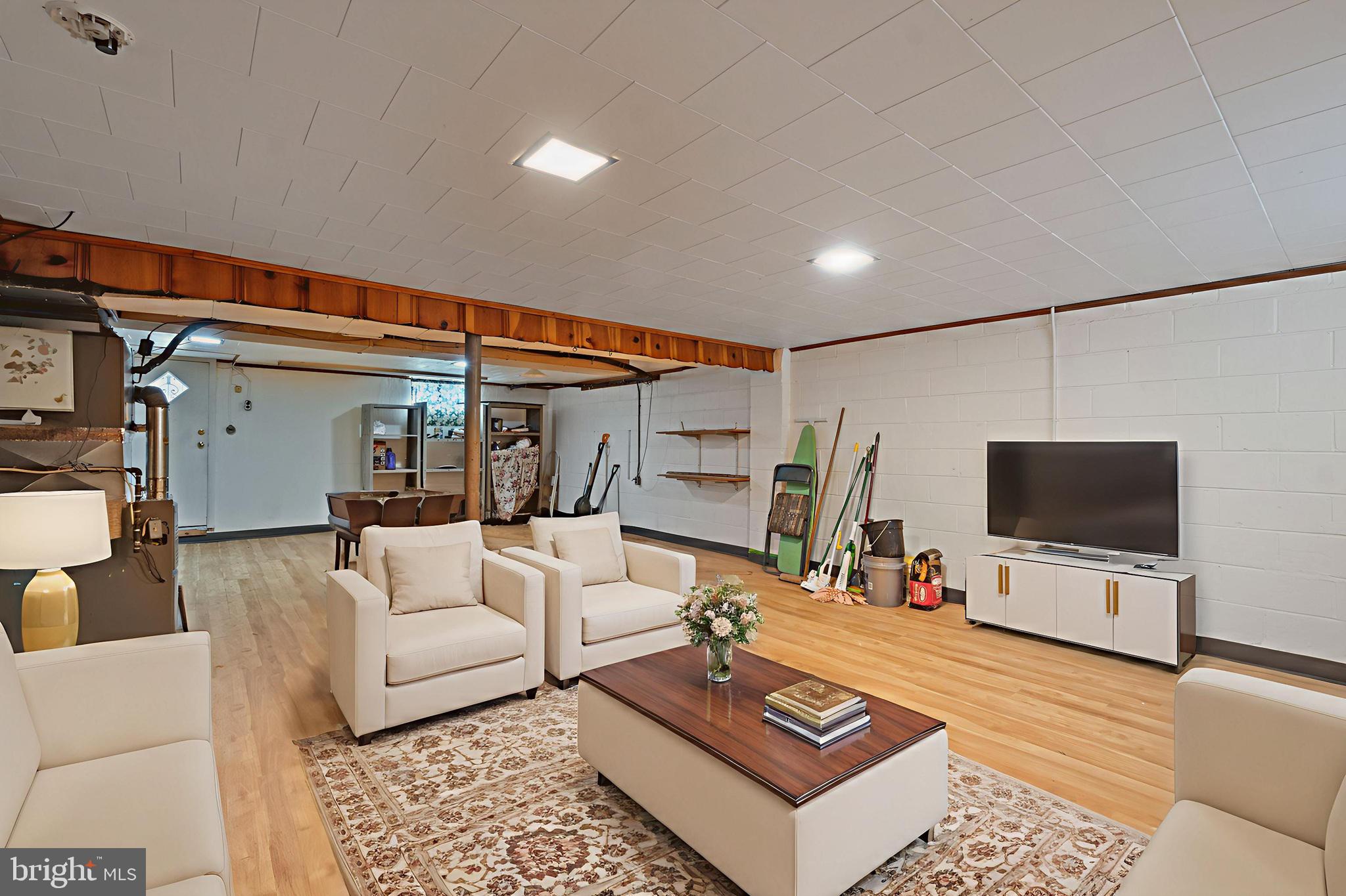 1909 Heathfield Road Baltimore, MD 21239 - Photo 15 of 22 a living room with furniture and a flat screen tv
