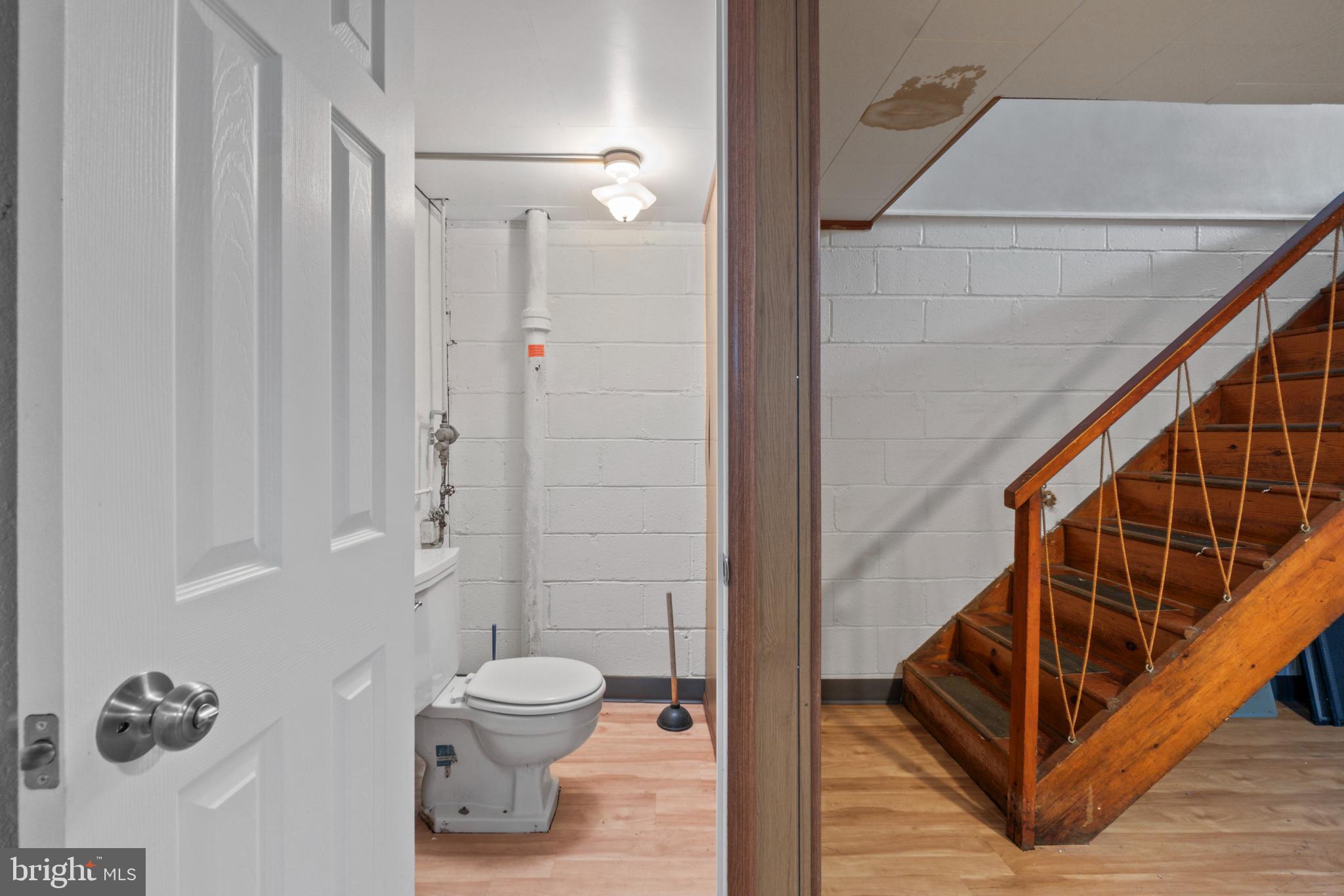 1909 Heathfield Road Baltimore, MD 21239 - Photo 16 of 22 a bathroom with a toilet and a shower