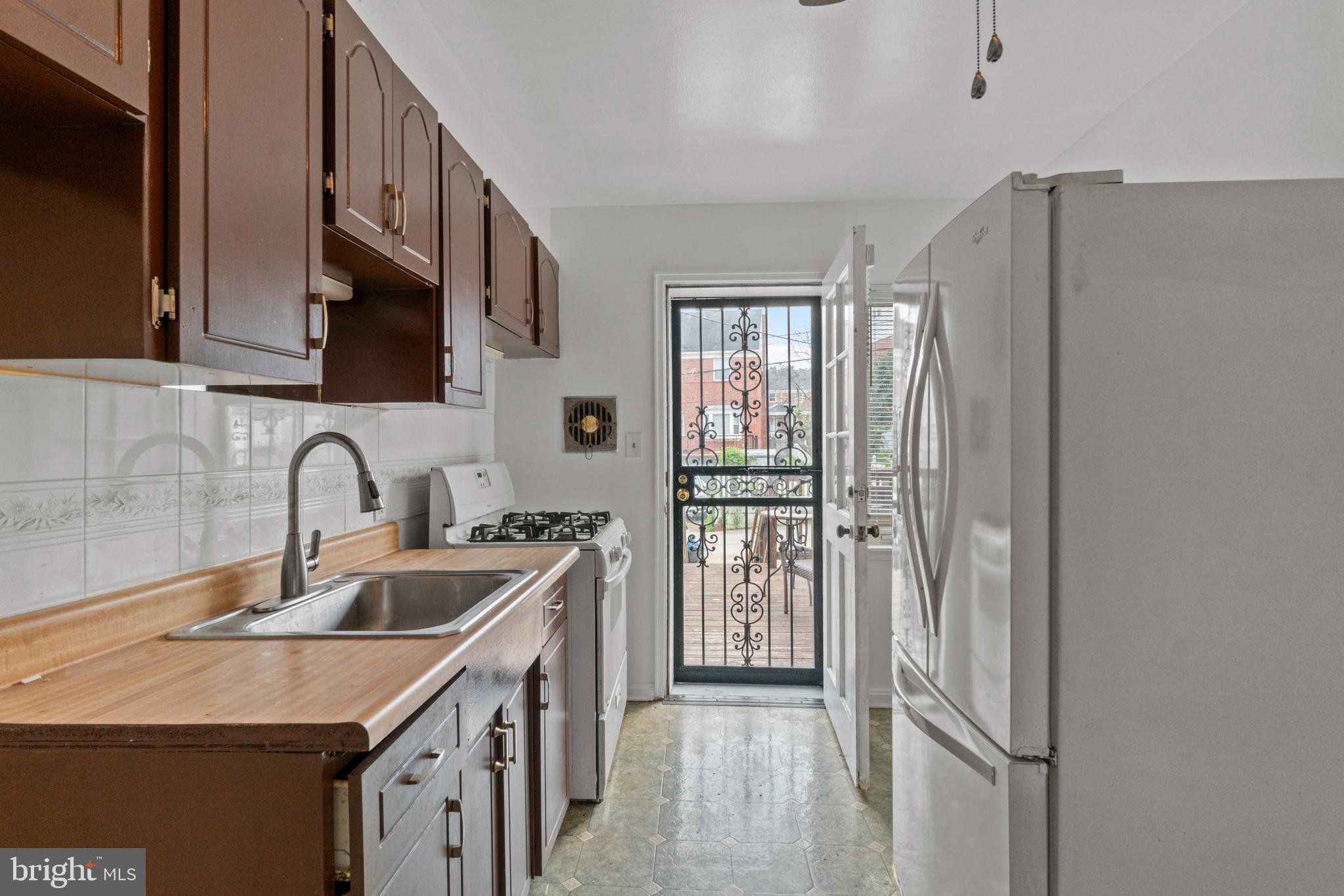 1909 Heathfield Road Baltimore, MD 21239 - Photo 5 of 22 a kitchen with stainless steel appliances granite countertop a refrigerator and a sink