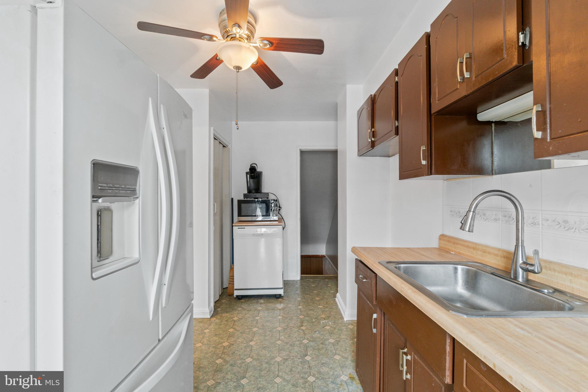 1909 Heathfield Road Baltimore, MD 21239 - Photo 7 of 22 a kitchen with refrigerator cabinets and sink