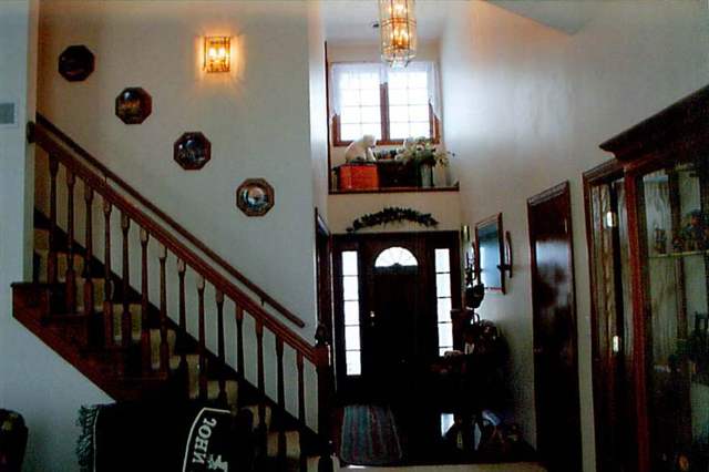 21626 Mill Road Prophetstown, IL 61277 - Photo 2 of 9 a view of staircase and living room with windows
