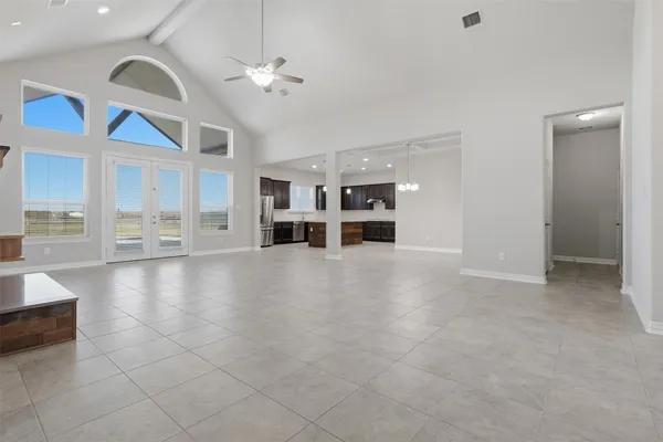 a view of an empty room with a kitchen