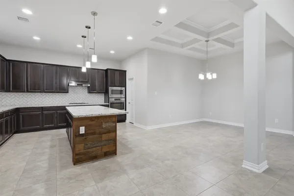 an open kitchen with cabinets and wooden floor
