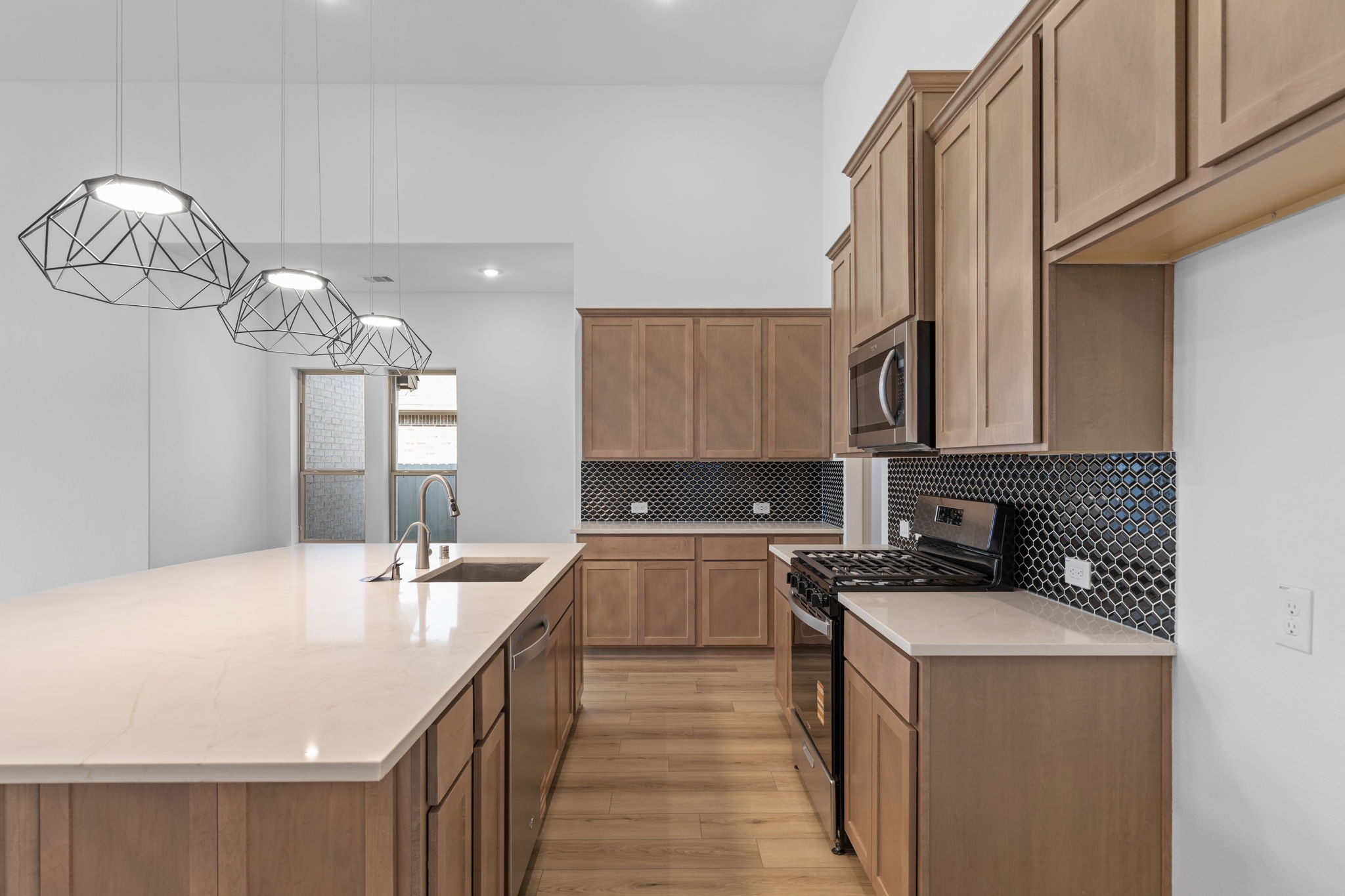 2518 Gleaming Pear Drive Manvel, TX 77578 - Photo 4 of 28 a kitchen with a sink stove and cabinets