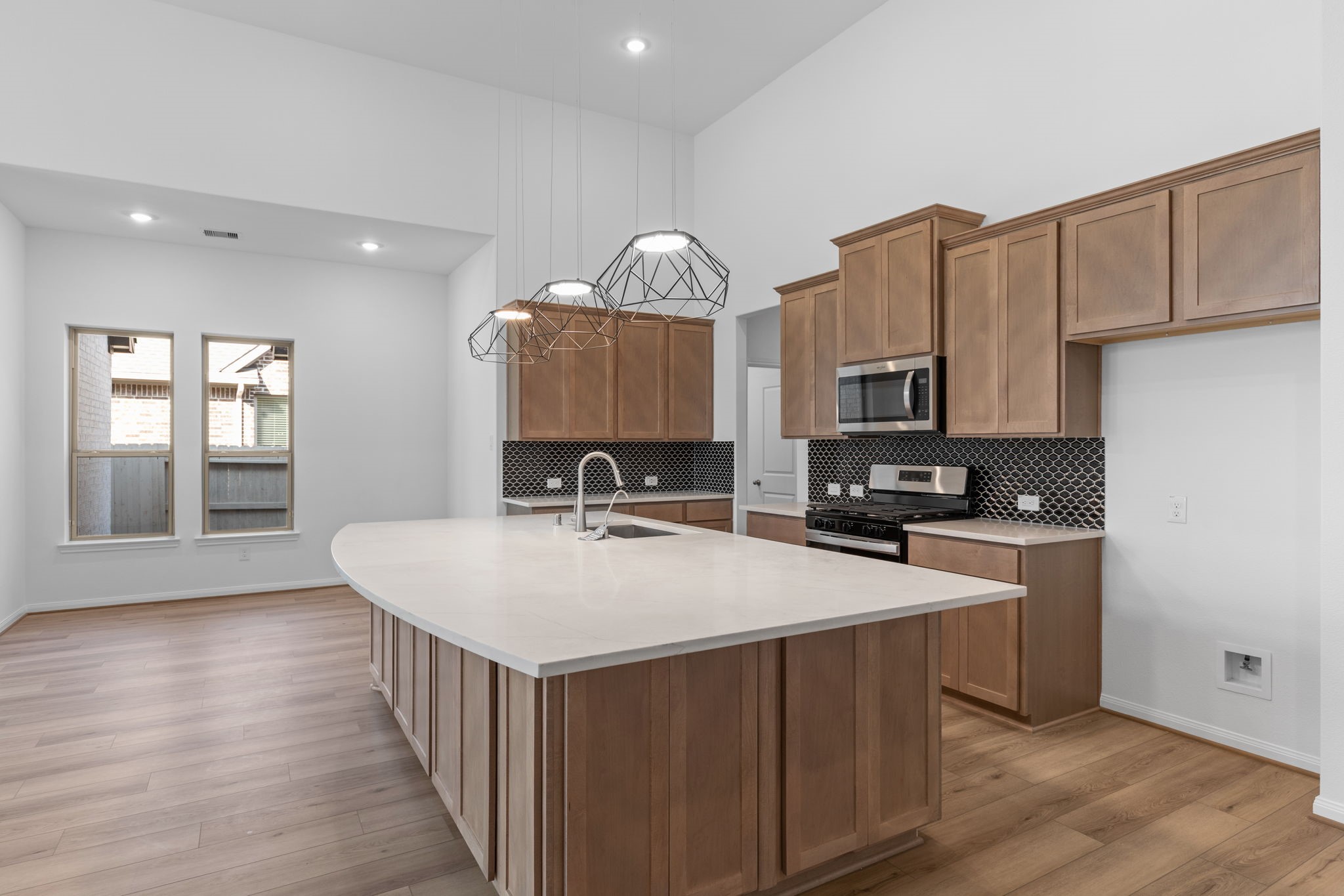2518 Gleaming Pear Drive Manvel, TX 77578 - Photo 5 of 28 a kitchen with a sink cabinets and wooden floor
