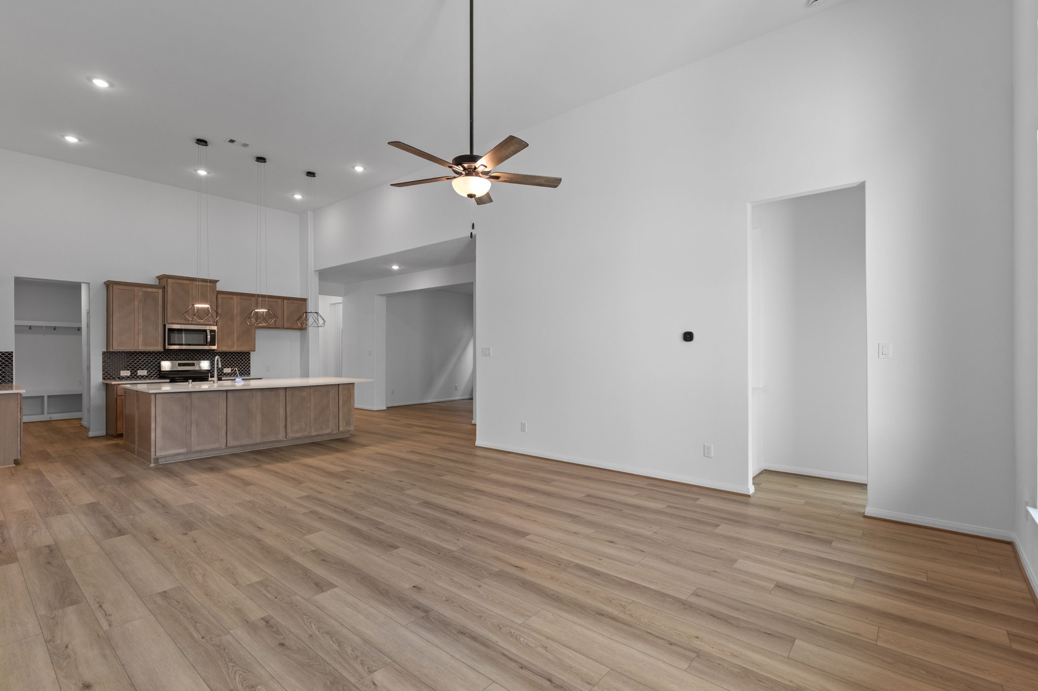 2518 Gleaming Pear Drive Manvel, TX 77578 - Photo 7 of 28 a view of kitchen and empty room with wooden floor