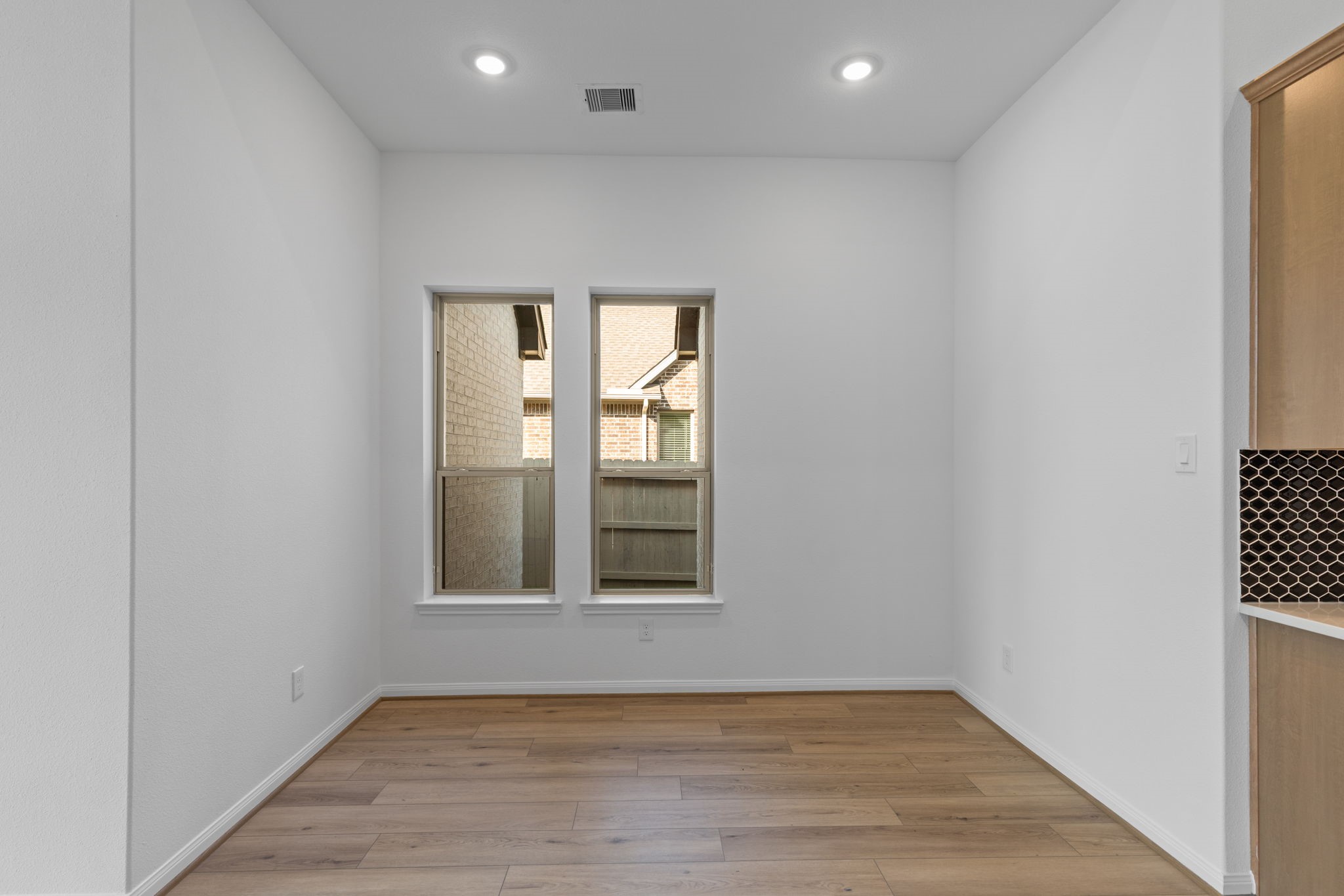 2518 Gleaming Pear Drive Manvel, TX 77578 - Photo 8 of 28 an empty room with wooden floor and windows